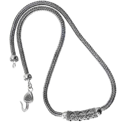 Brighton necklace with sterling silver braided chain, ornate scrollwork centerpiece, and hook clasp on a white background
