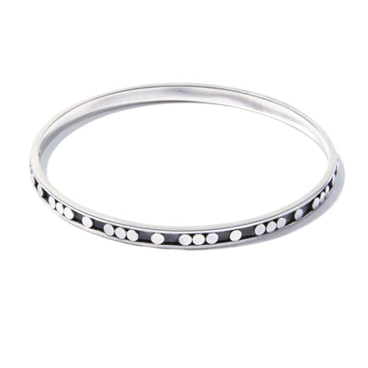 Brighton bangle bracelet in sterling silver with raised dot detailing along the outer edge on a white background
