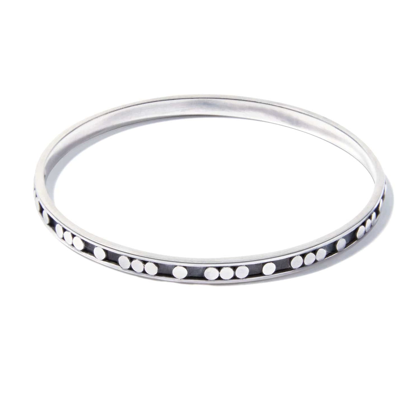 Brighton bangle bracelet in sterling silver with raised dot detailing along the outer edge on a white background