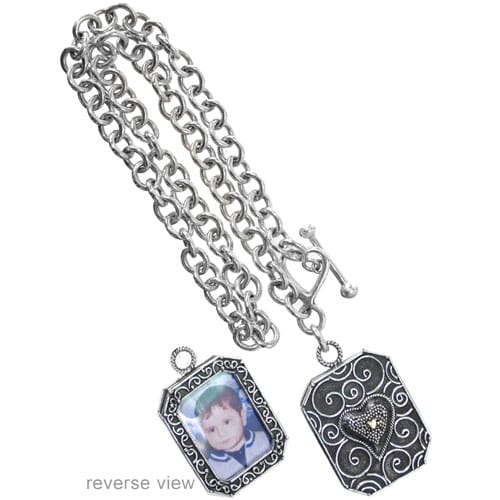 Brighton photo locket necklace with sterling silver chain, engraved scroll frame, and heart medallion reverse view on a white background