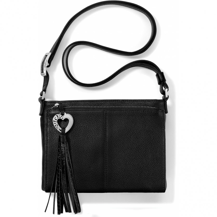 Brighton crossbody handbag in black leather with silver-tone heart charm and braided tassel on a white background