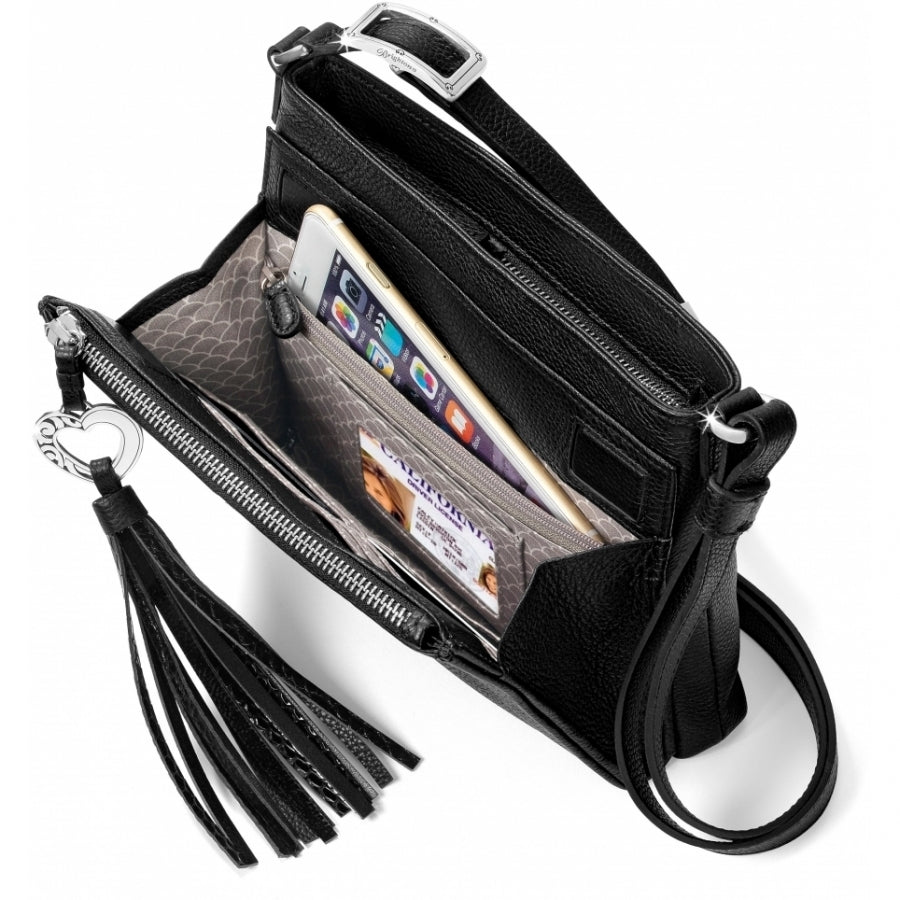 Brighton black leather crossbody handbag shown open with phone, ID card, tassel, and silver heart charm on a white background