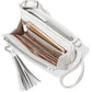Brighton white leather handbag shown open with interior card slots, phone pocket, and silver-tone tassel on a white background