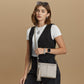 Model with a Brighton metallic leather crossbody handbag with tassel and silver heart charm, styled with coordinating Brighton accessories