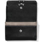 Brighton black leather wallet shown open with tan interior card slot and silver-tone snap closures on a white background