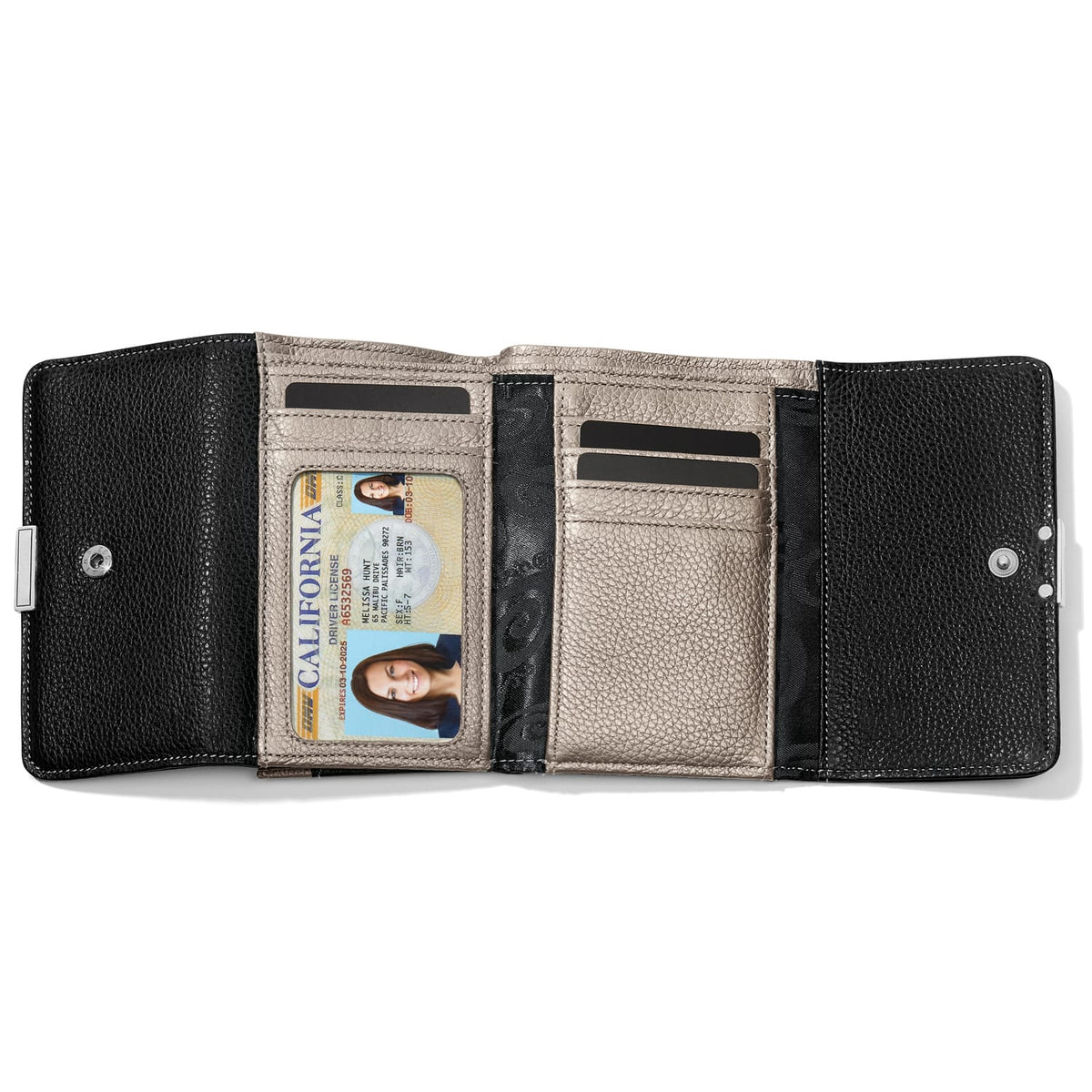 Brighton trifold wallet shown open with black exterior, metallic interior, ID window, and card slots on a white background