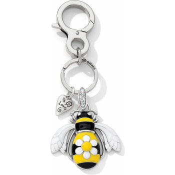 Brighton bee key fob with yellow and black enamel, white daisy accent, and crystal-set bail on a white background