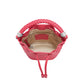 Brighton pink leather bucket handbag shown from above with braided handle, drawstring closure, and patterned interior lining on a white background