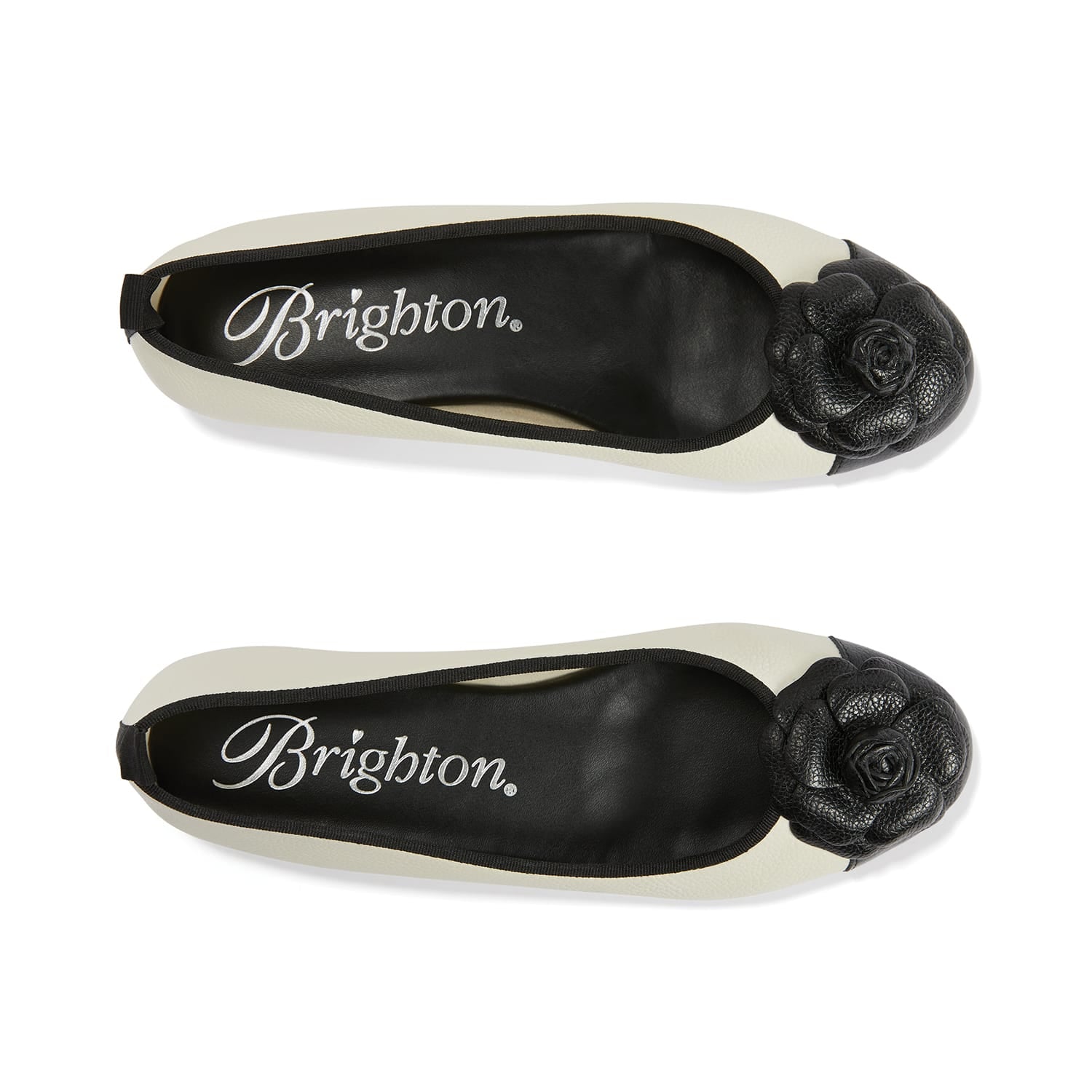 Brighton ballet flats in cream leather with black rosette toe caps and black trim on a white background