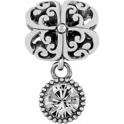 Brighton charm with silver-plated scrollwork design and dangling round crystal in beaded setting on a white background