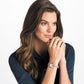 Model wearing a Brighton silver-tone watch with round dial and beaded charm bracelet band