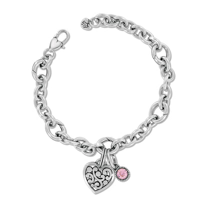 Brighton charm bracelet with silver-plated chain, filigree heart charm, and pink crystal accent on a white background