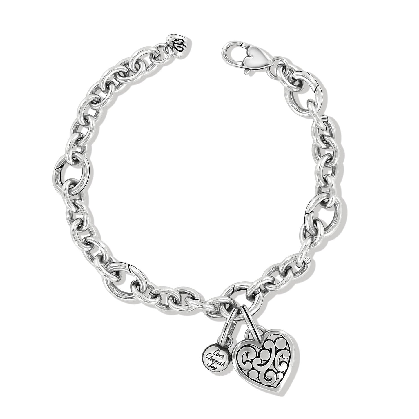 Brighton charm bracelet with silver-plated link chain, filigree heart charm, and engraved round charm on a white background