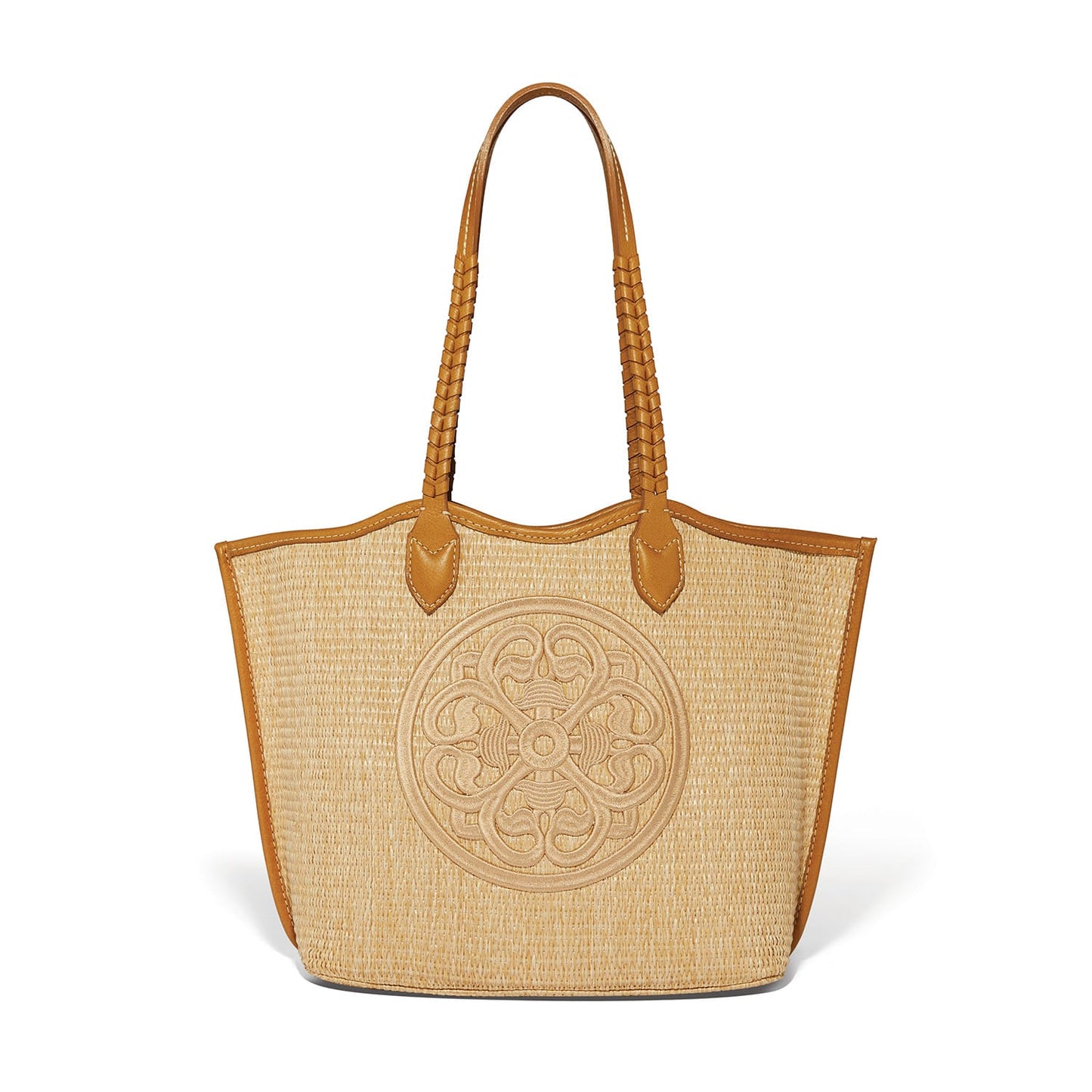 Brighton straw tote handbag with tan leather trim, braided handles, and embroidered medallion design on a white background