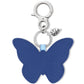 Brighton butterfly bag charm in blue leather with silver-tone clasp and heart accent on a white background