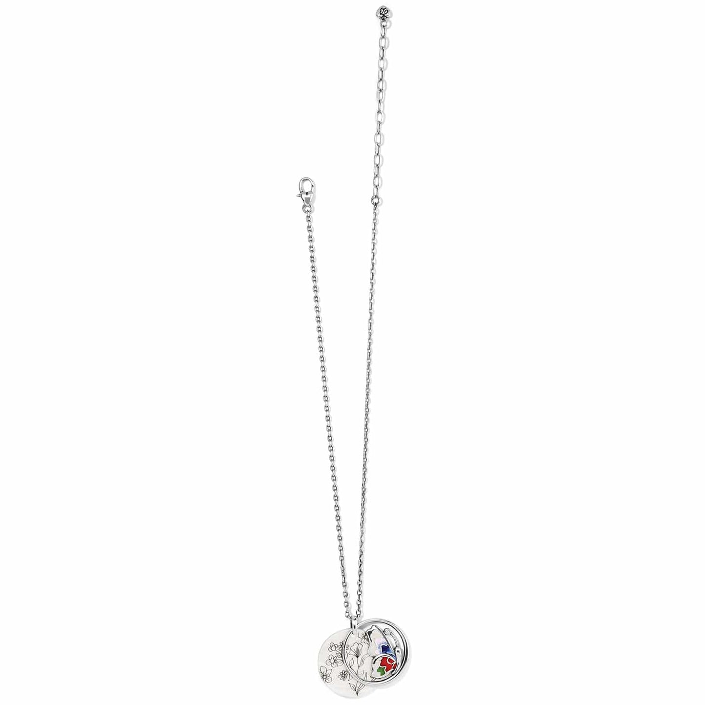 Brighton silver-plated pendant necklace with floral engraved disc and enamel charm with crystal accents on a white background