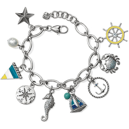 Brighton silver-plated charm bracelet with nautical charms including anchor, seahorse, sailboat, crab, and ship wheel on a white background