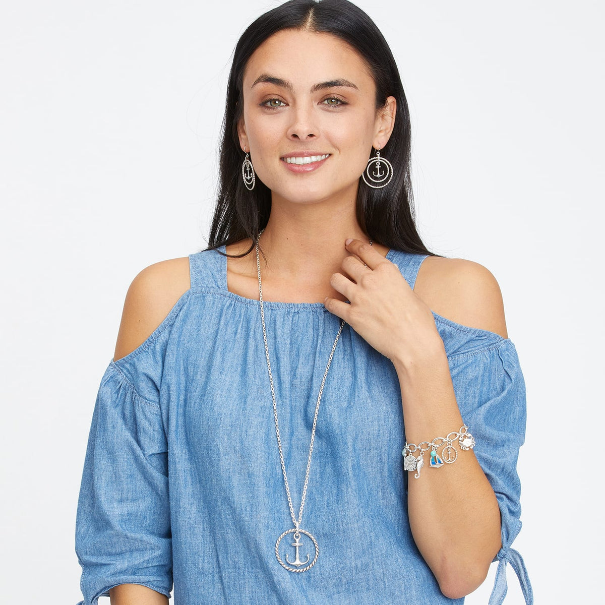 Model wearing Brighton silver-plated anchor pendant necklace with coordinating hoop earrings and nautical charm bracelet