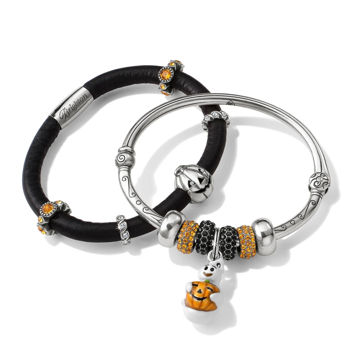 Brighton bracelets with black leather band, silver-plated bangle, orange crystals, and enamel pumpkin ghost charm on a white background