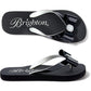 Brighton black rubber flip-flop sandals with glossy bow accent and crystal centerpiece, shown from two angles on a white background