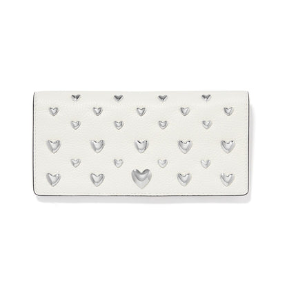Brighton white leather wallet embellished with polished silver-tone heart studs in varying sizes on a white background