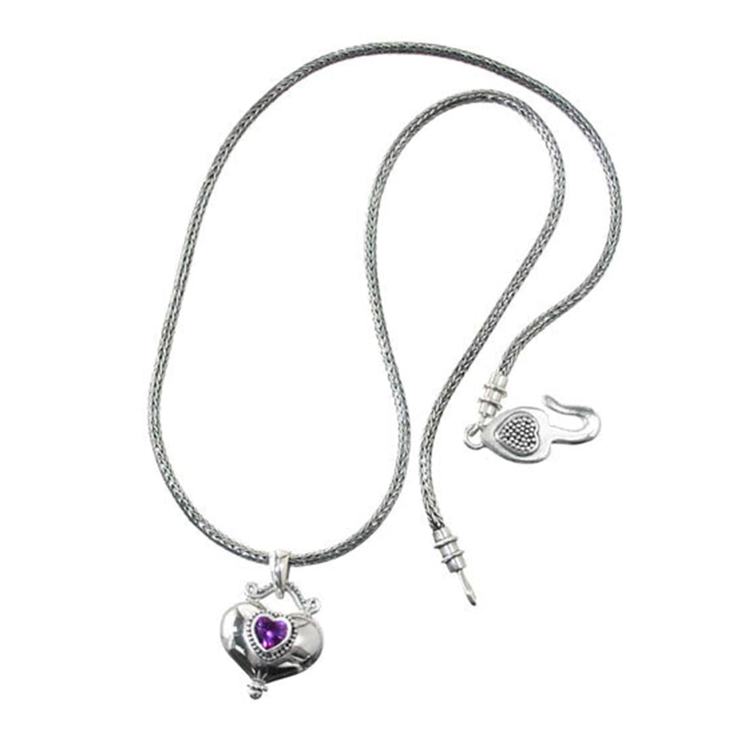 Brighton necklace in sterling silver with woven chain, heart pendant featuring purple crystal, and hook clasp on a white background