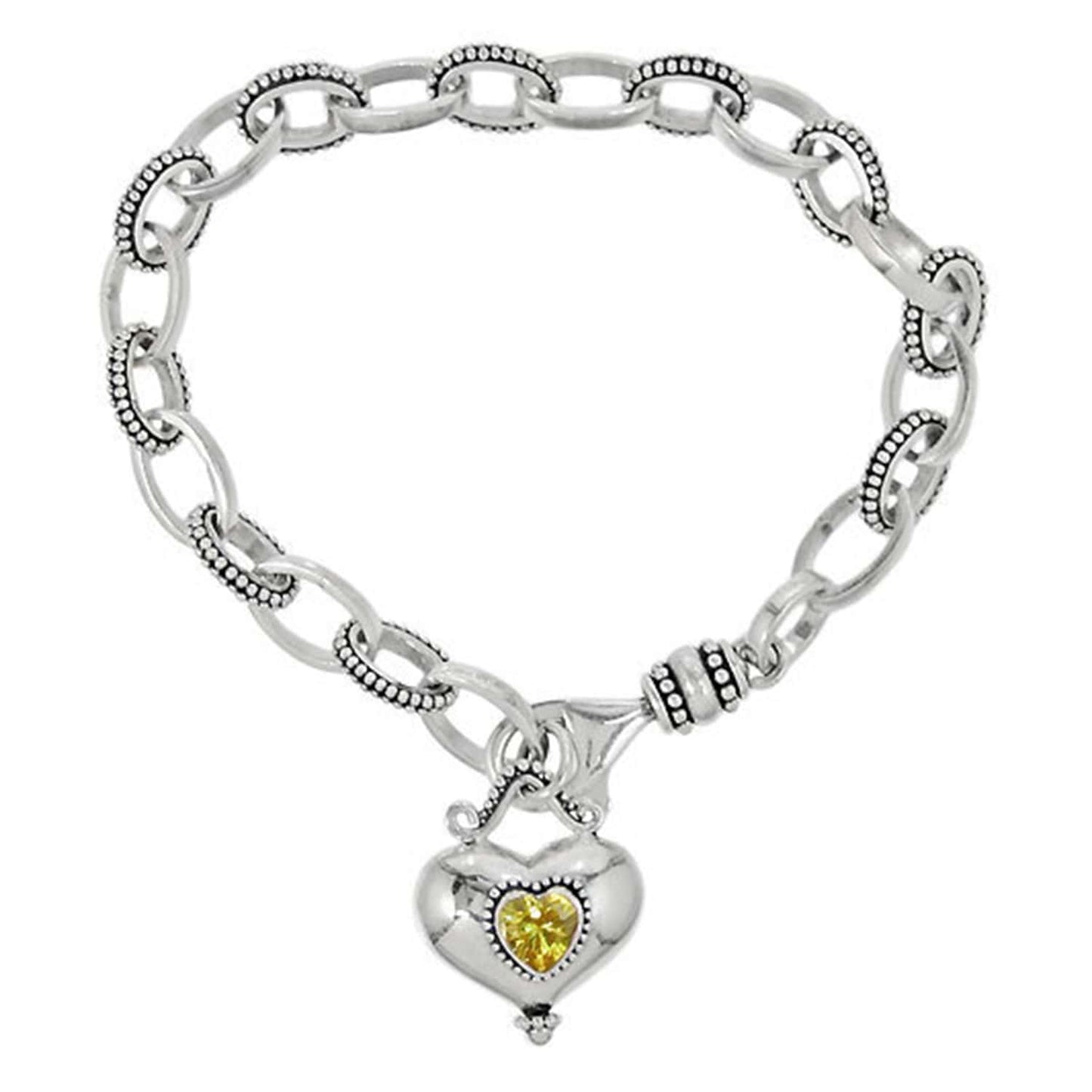 Brighton charm bracelet with sterling silver oval links and heart pendant featuring yellow crystal on a white background