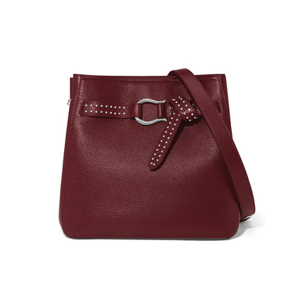 Brighton burgundy leather handbag with studded belt detail, silver-tone buckle, and adjustable shoulder strap on a white background