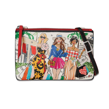 Brighton crossbody handbag with illustrated shopping scene print, red trim, and black adjustable strap on a white background