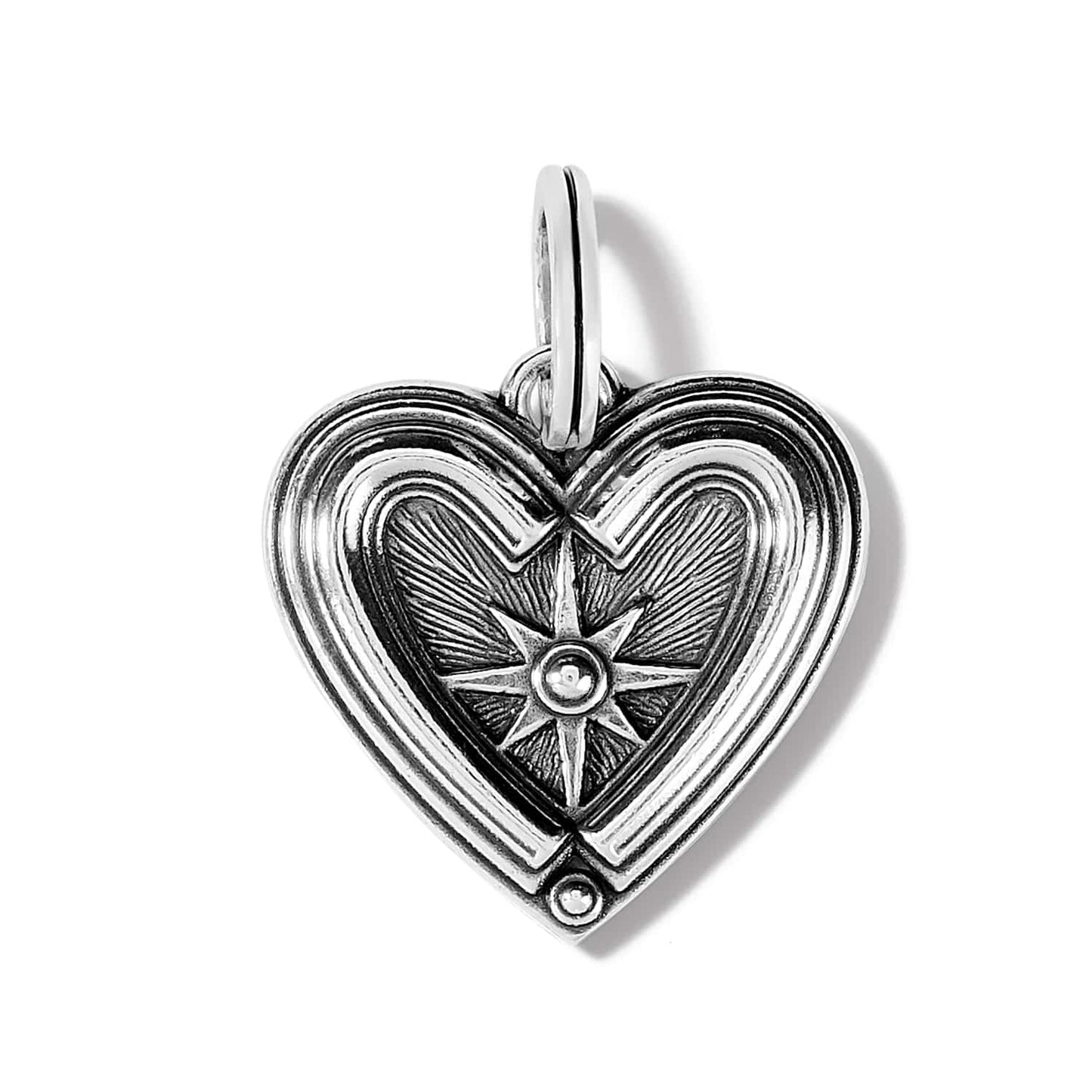 Brighton heart charm with silver-plated ridged border and engraved compass star center detail on a white background