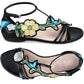 Brighton black leather ankle-strap sandals with embroidered floral and butterfly appliqués, shown from two angles on a white background