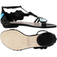 Brighton flat sandals in black leather with blue floral embroidery and T-strap design, sole view shown, on a white background