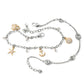 Brighton charm bracelet and anklet set with silver-plated swirls, brushed gold sea charms, and glass pearls on a white background
