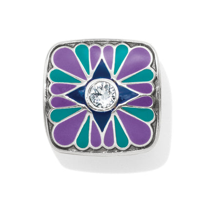 Brighton square charm with purple and teal enamel petals surrounding a blue star and crystal center on a white background