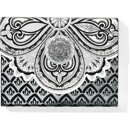 Brighton card case with black and silver ornamental scroll print and crystal medallion accent on a white background