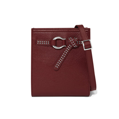 Brighton burgundy leather crossbody handbag with studded knotted belt detail and silver-tone buckle strap on a white background