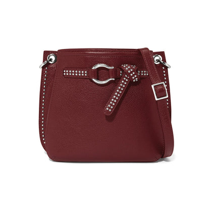 Brighton burgundy leather crossbody handbag with studded trim, silver-tone ring buckle, and adjustable strap on a white background