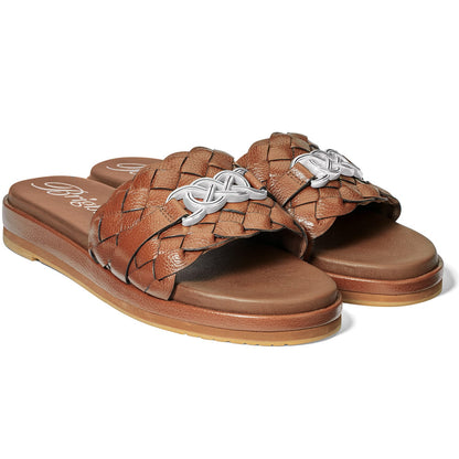 Brighton slide sandals in brown braided leather with silver-tone interlocking ornament and molded footbed on a white background