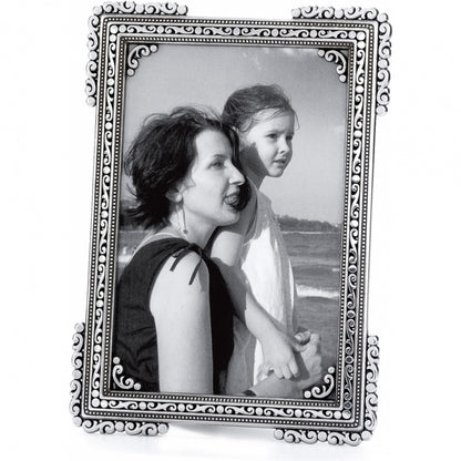 Brighton picture frame with silver-plated ornate scroll and beaded border holding a black and white photo on a white background