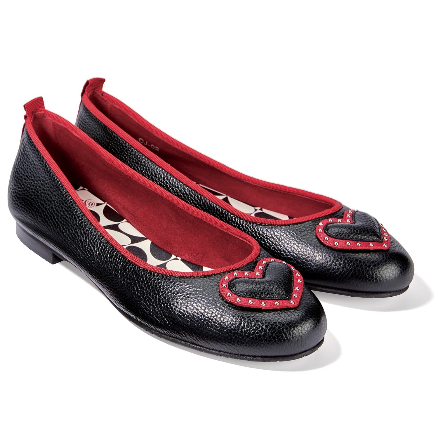 Brighton black leather ballet flats with red trim and studded red heart appliqué on a white background