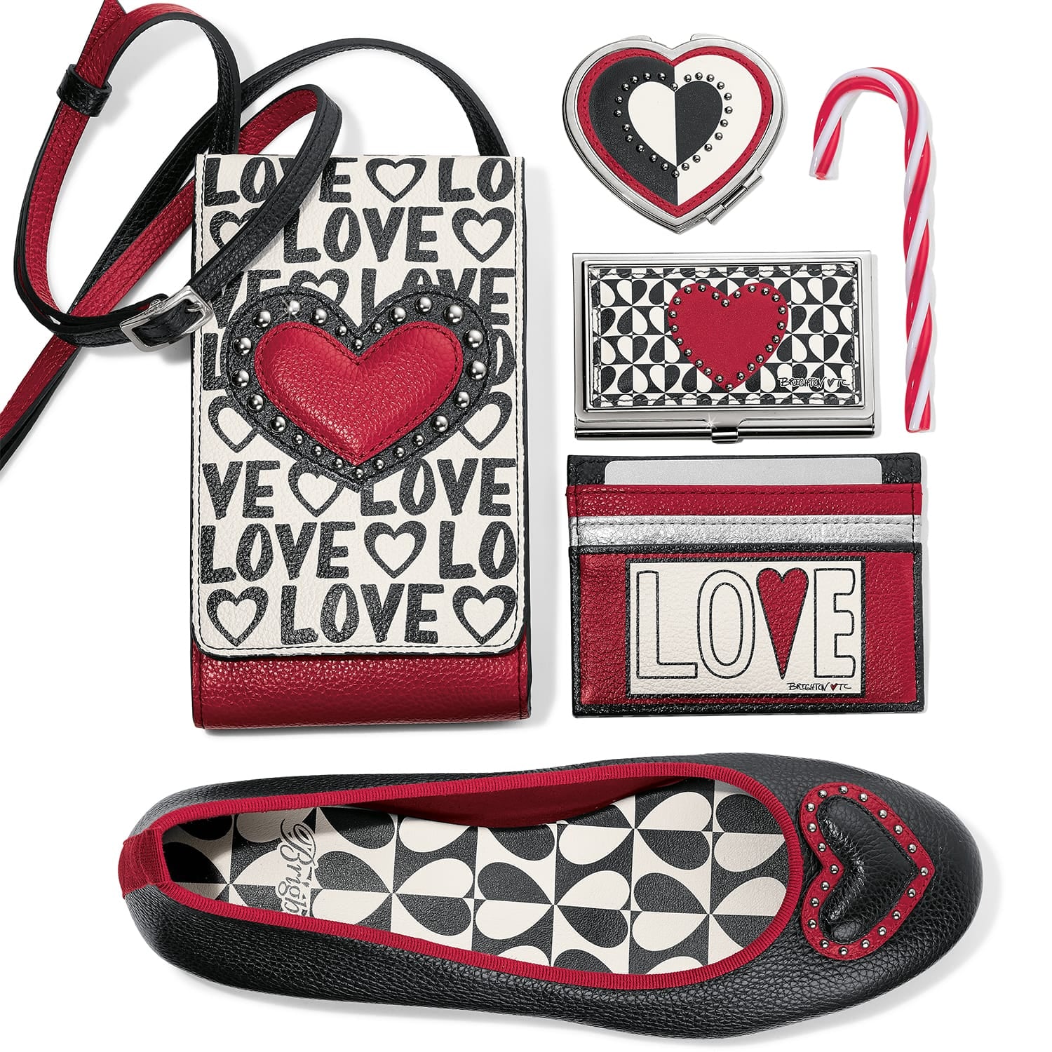 Brighton phone crossbody with LOVE print styled with heart accessories and a candy cane on white background