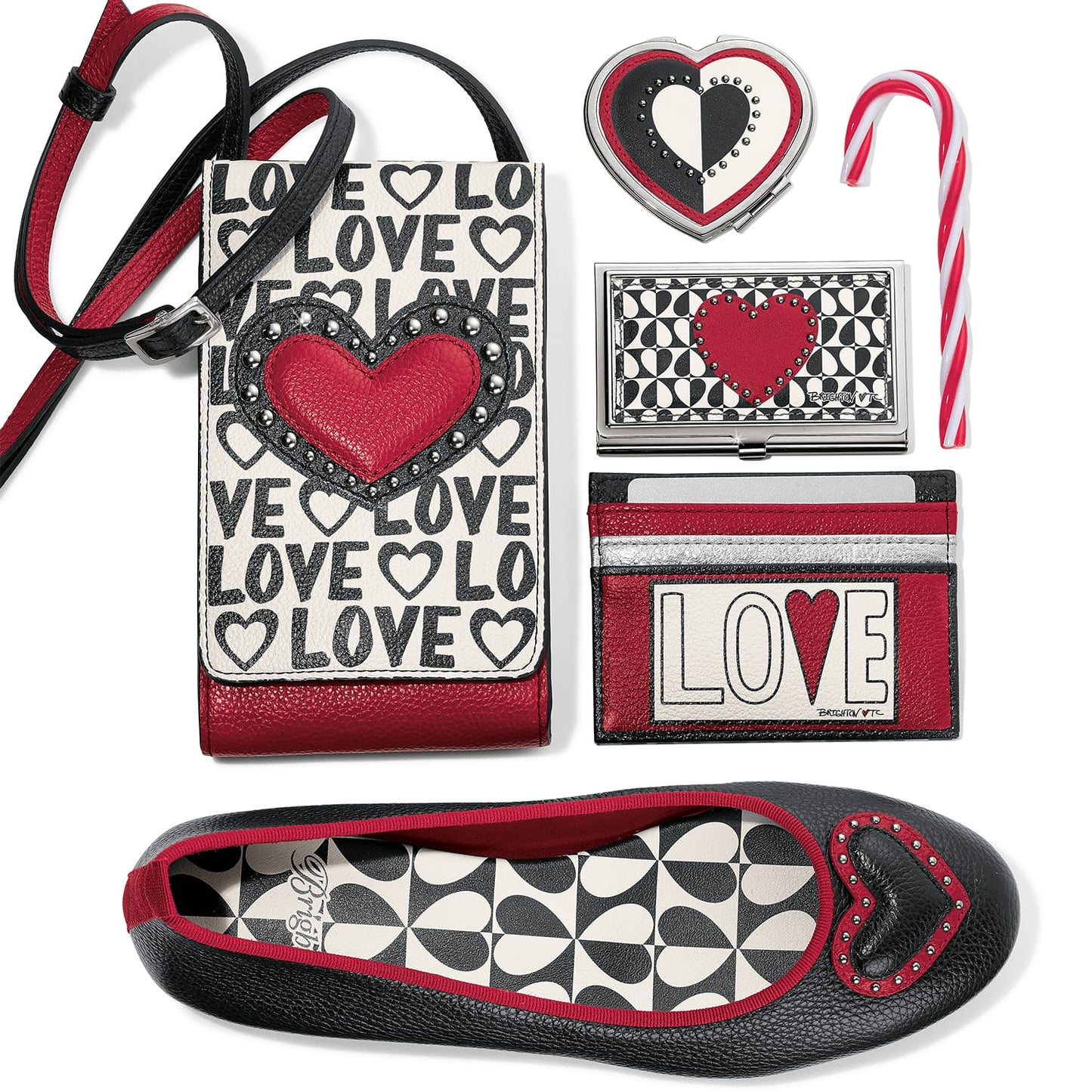 Brighton phone crossbody with LOVE print styled with heart accessories and a candy cane on white background