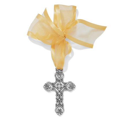 Brighton silver-plated cross ornament with scrollwork, heart details, crystal accents, and sheer gold ribbon on a white background