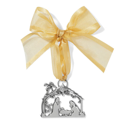 Brighton silver-plated nativity ornament with Peace on Earth cutout, crystal star, and gold organza bow on a white background