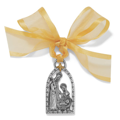 Brighton nativity ornament with silver-tone Holy Family figures, gold-tone star, and yellow organza ribbon bow on a white background