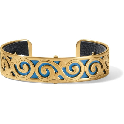 Brighton cuff bracelet with gold-plated scroll design over blue and black leather inlay on a white background