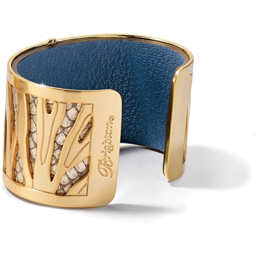Brighton cuff bracelet with gold-plated finish, cutout design, and blue leather interior lining on a white background