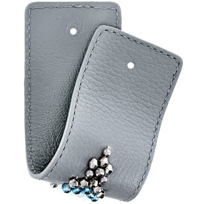 Brighton gray leather jewelry pouches with stitched edges and blue crystal beaded earrings peeking out on a white background