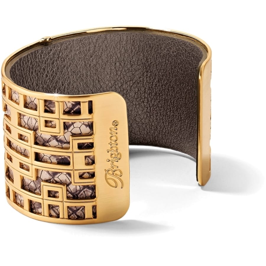 Brighton gold-plated cuff bracelet with geometric cutout design over snakeskin print interior on a white background