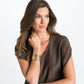 Model wearing a Brighton gold-plated wide cuff bracelet with textured openwork design and crystal accents